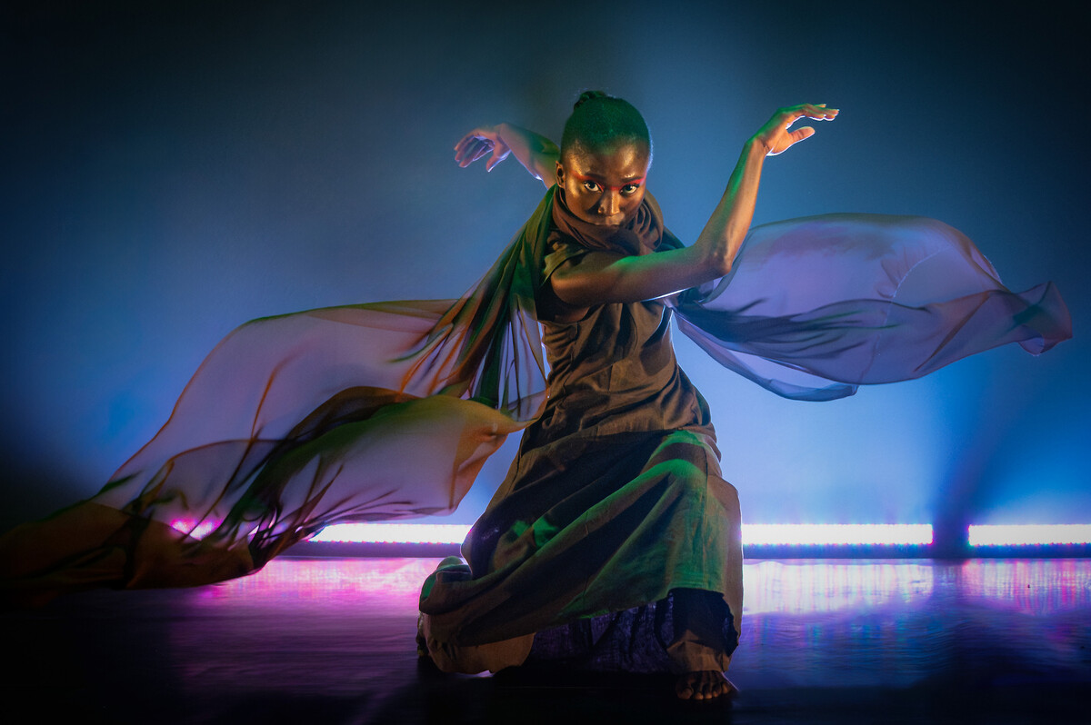 A grounded powerful female dancer, intent and in motion