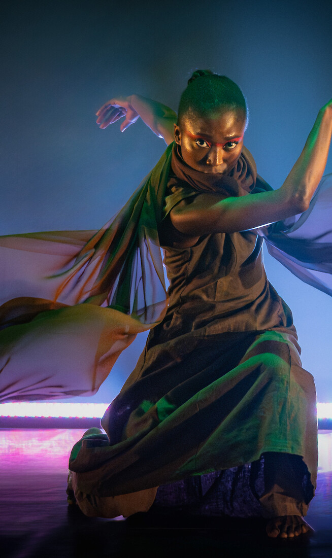 A grounded powerful female dancer, intent and in motion