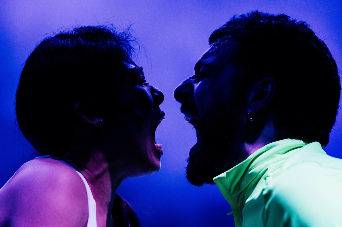 Two faces screaming at each other against a purple background.