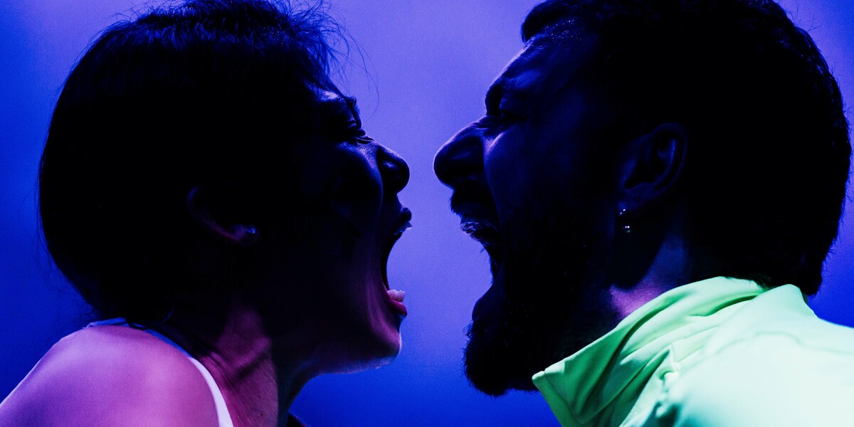 Two faces screaming at each other against a purple background.