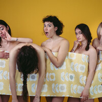 Image of five dancers standing in a line with a piece of wallpaper connecting them