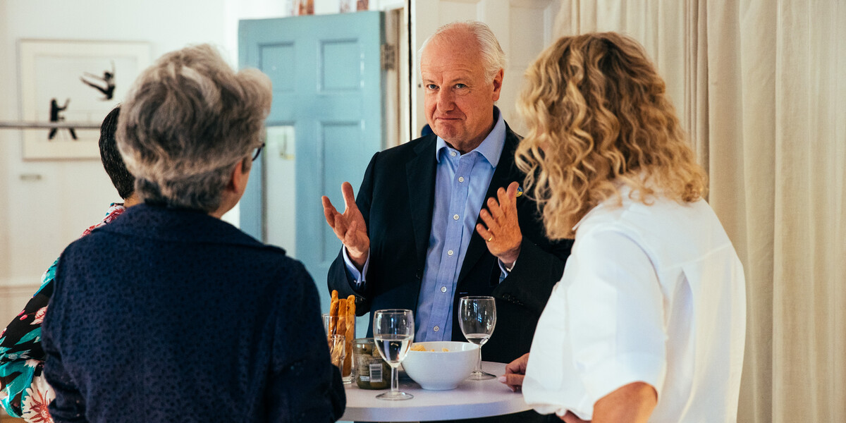 Image of Lord Simon Russell, patron of The Place, with guests at 2022 Graduation drinks reception