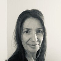 Black and white headshot of Andrea, a white woman