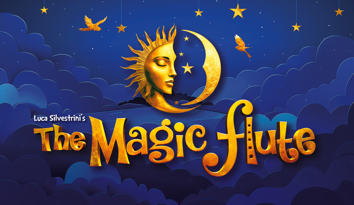 A navy blue background with clouds. Golden stars and birds hang down from the clouds. A large golden sun and moon in the centre with the words ‘The Magic Flute’ written in golden 3D writing underneath.