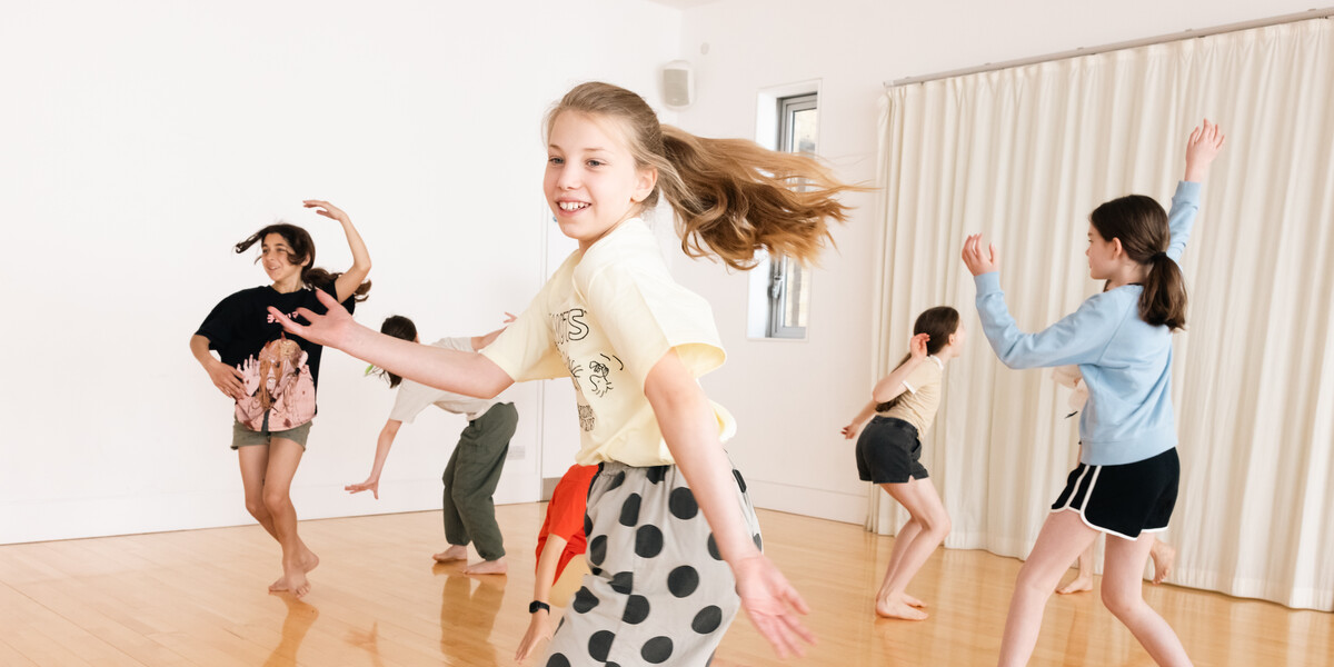 Children aged 12 spinning around a dance studio