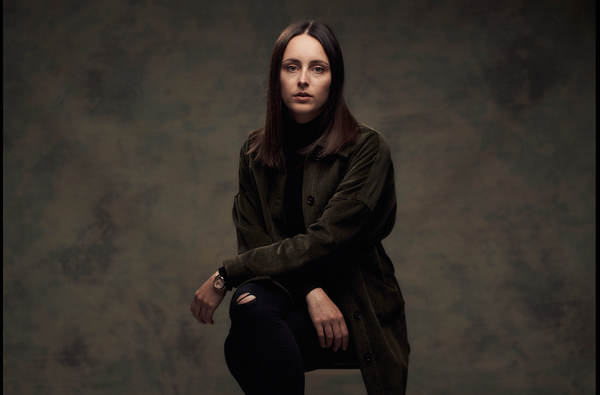 Margo's headshot against a dark backdrop