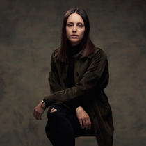 Margo's headshot against a dark backdrop